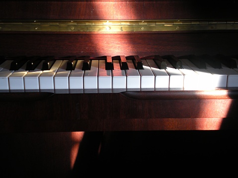 a piano keyboard in sunlight