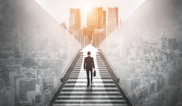 Ambitious business man climbing stairs to success. stock photo