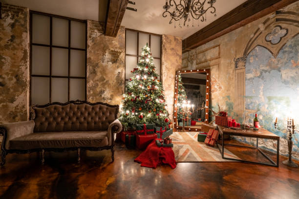 istock Christmas evening by candlelight. classic apartments with a fireplace, decorated tree, sofa, large windows and chandelier. 1189059700