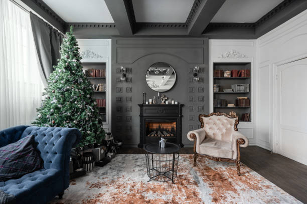 istock Christmas morning. Classic apartments with study and library a fireplace, decorated tree, sofa, large windows and chandelier. 1189061993