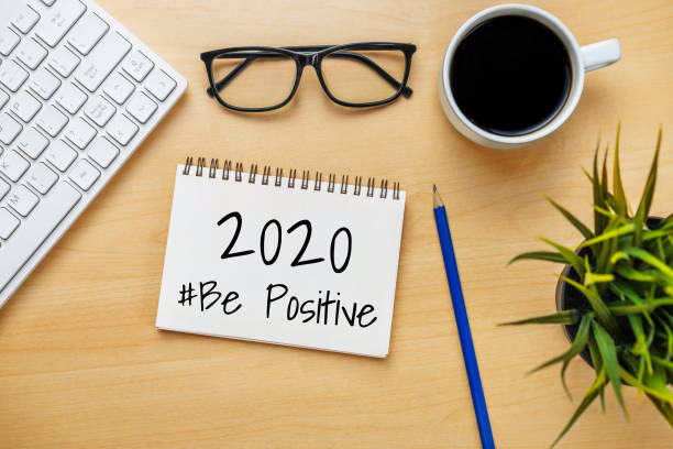 istock New Year Resolution Goal List 2020 - Business office desk with notebook written in handwriting about plan listing of new year goals and resolutions setting. 1189063247