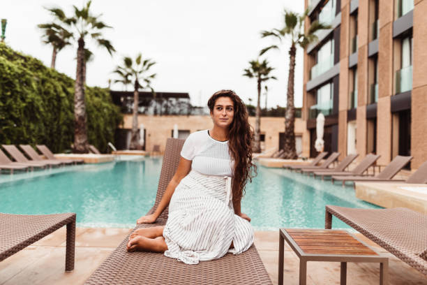 istock woman resting on the pool 1189063279