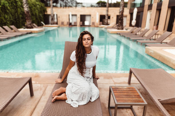 istock woman resting on the pool 1189063295