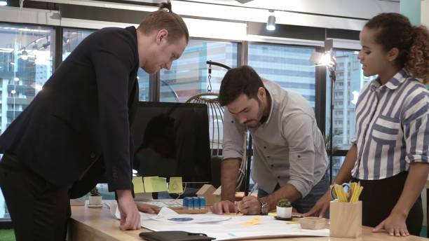 istock Creative business people group having conversation at office desk in workplace. 1189063969
