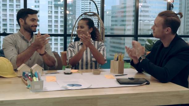 istock Creative business people group having conversation at office desk in workplace. 1189063988