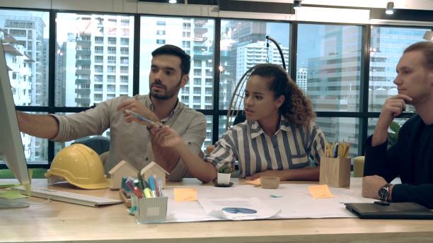 istock Creative business people group having conversation at office desk in workplace. 1189064005
