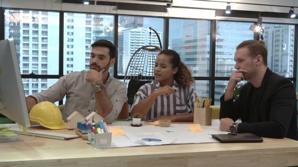 istock Creative business people group having conversation at office desk in workplace. 1189064054