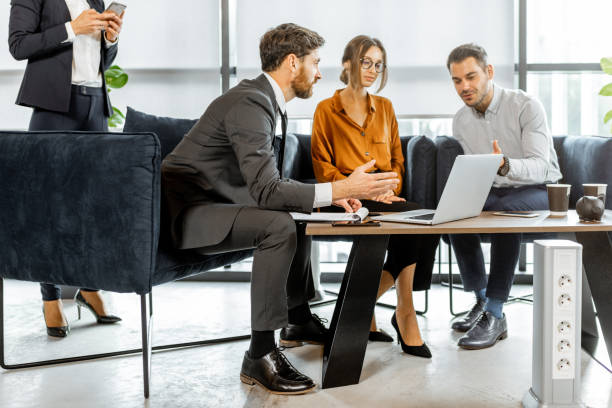 istock Young couple with financial advisor at the office 1189065453
