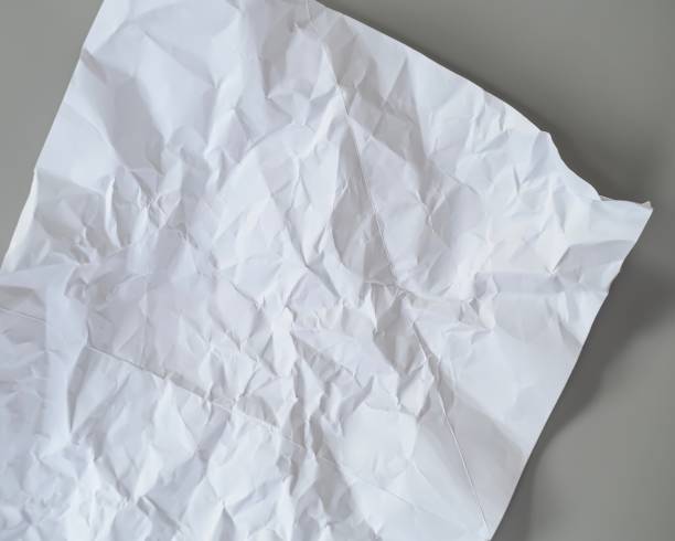 istock crumpled white paper, White paper texture background blurred. 1189067985