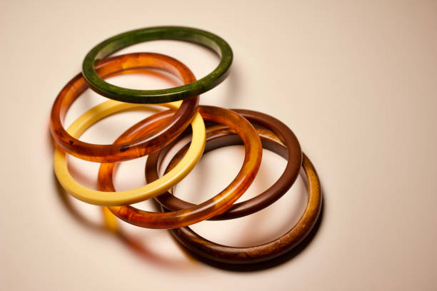 istock Close-up view of multi-color vintage bakelite bangle bracelets on a white background 1189069002