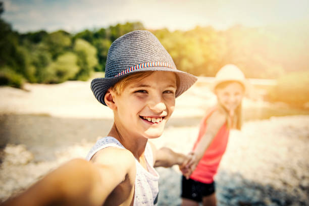 istock Brother and sister doing selfie with smartphone 1189070565