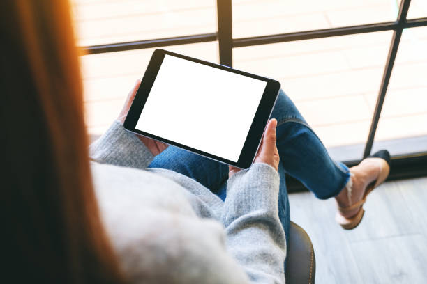 istock a woman holding black tablet pc with blank white screen 1189078922