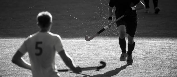 istock Men Playing Hockey On Field 1189081372