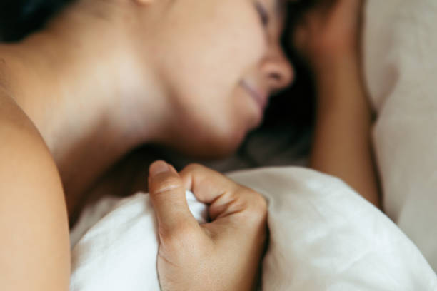 istock woman sleeping in bed close up blurred 1189082004
