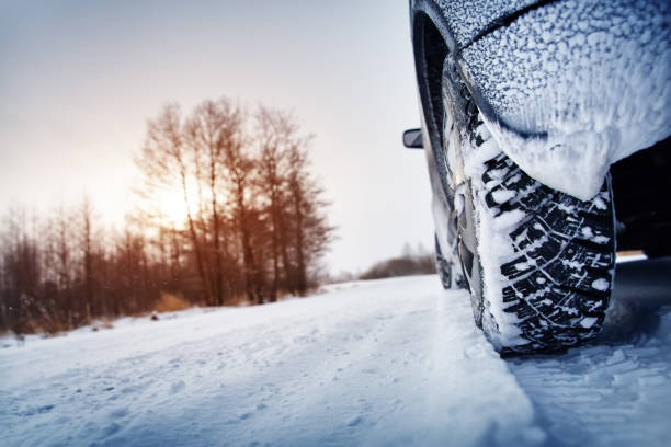 istock Car tires on winter road covered with snow 1189083104