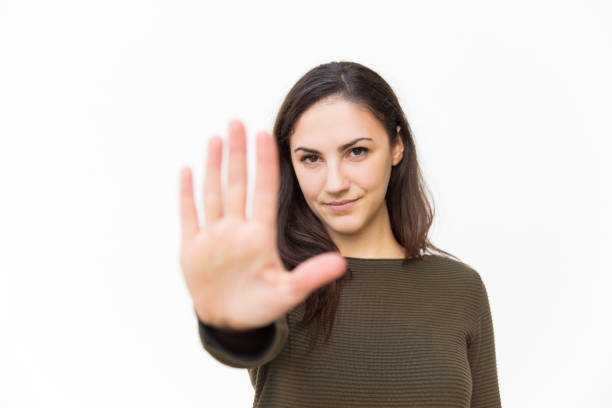 istock Serious confident beautiful woman making hand stop gesture 1189084471
