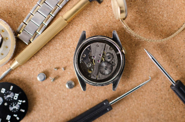 istock Top view of opened watch case, battery, screwdrivers on the cork surface 1189084518