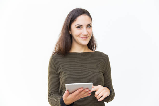 istock Smiling confident beautiful woman holding tablet 1189084562