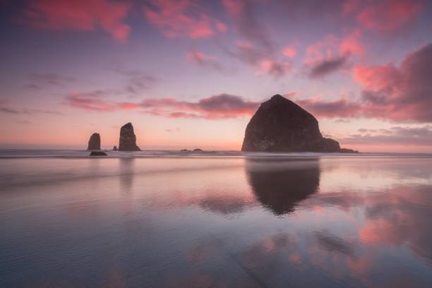 istock The Sunset at Cannon Beach with Dramatic clouds in the background and a nice reflection in water.  Dramatic coastal seascape featuring scenic rock formations Haystack Rock Oregon, USA 1189085202