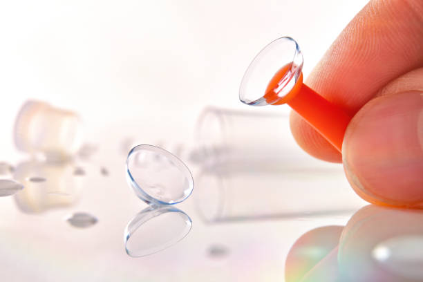 istock Fingers catching a lens with an applicator on table 1189086408