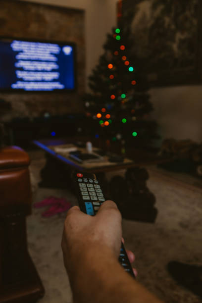 istock Christmas tree and big tv in dark room 1189086735