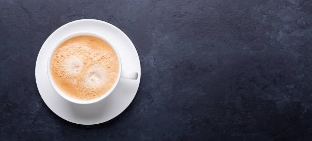 istock Cup of coffee on black stone background Horizontal banner 1189086745