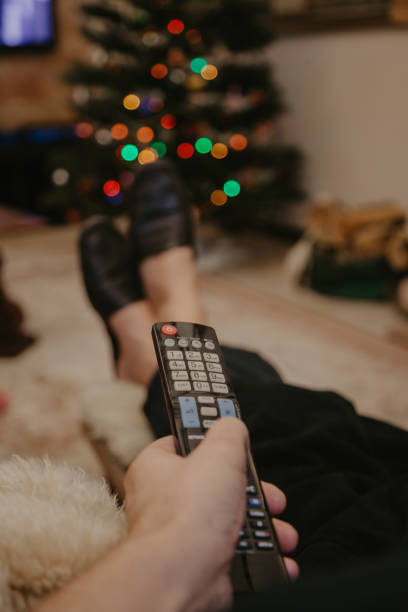istock Close-up of man hand holding  TV remote control 1189087390