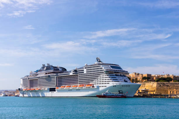 Santorini island, Greece - April, 23, 2023: Cruise ship near the coast. Blue sea and the blue sky. Summer seascape. Travel and vacation concept