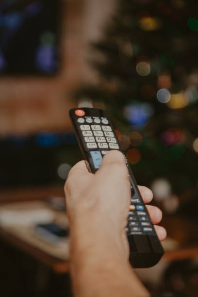 istock Hand holds remote control from TV closeup 1189087463
