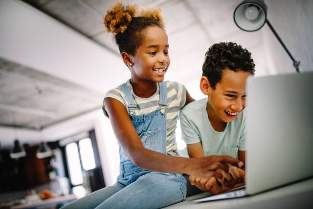 istock Kids, technology concept. Happy children using laptop to learn, play, fun. 1189087493