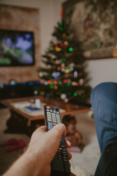 istock Close-up of man hand holding  TV remote control 1189087506