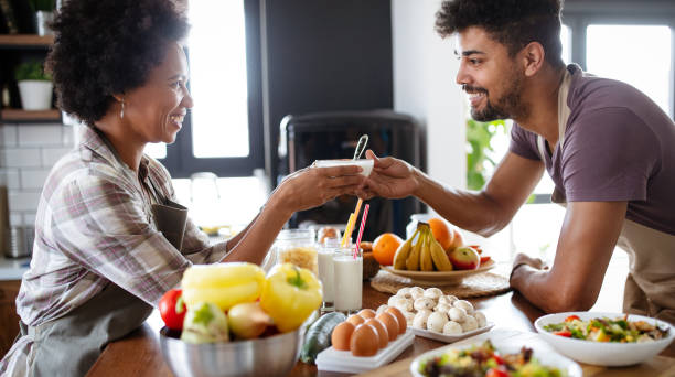 istock Happy couple preparing healthy food in kitchen 1189088182
