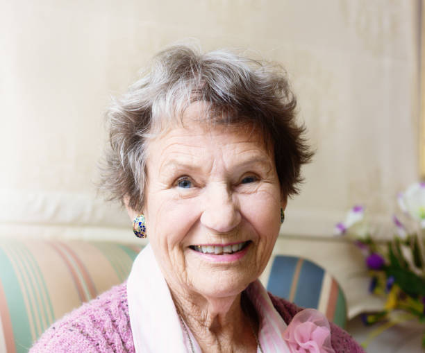 istock Smiling senior woman relaxing at home 1189089789