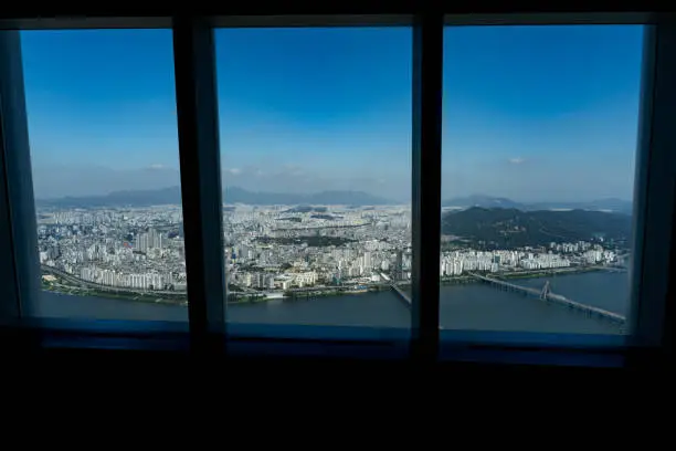 Good view at Seoul city, river and bridges from the top of lotte world tower through huge panorami windows