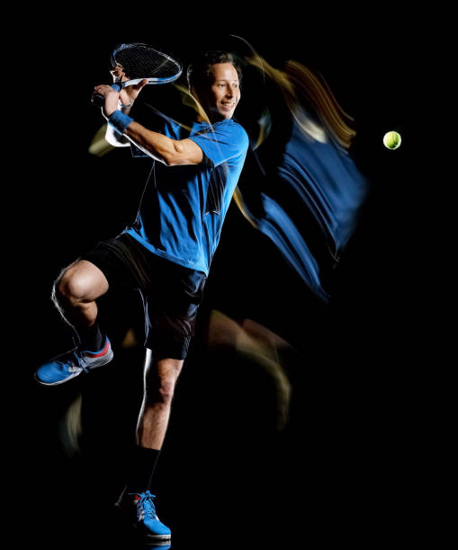 istock tennis player man isolated black background light painting speed motion 1189091473