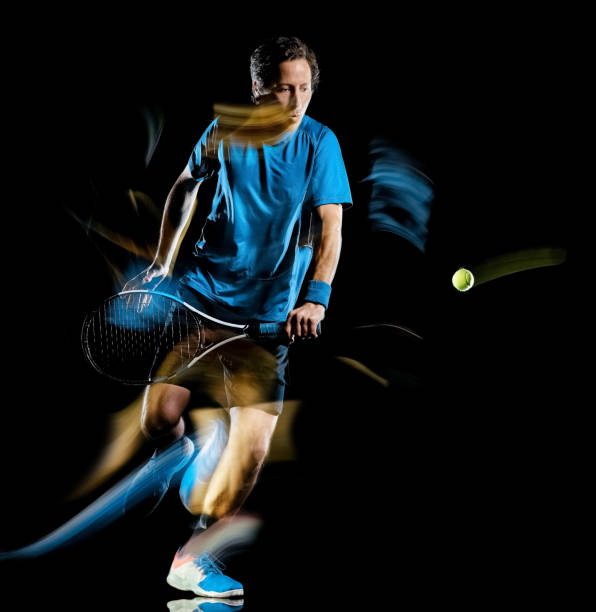 istock tennis player man isolated black background light painting speed motion 1189091485