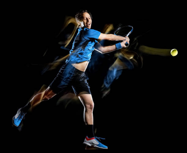 istock tennis player man isolated black background light painting speed motion 1189091503