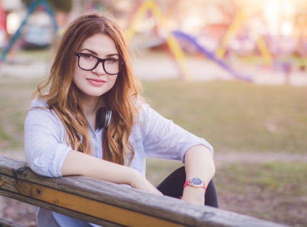 istock Woman with headsets sitting on bench and relaxing 1189093616
