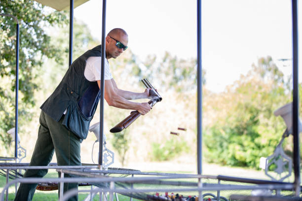 istock Adult Man Reloading Shotgun on Shooting Range 1189094137