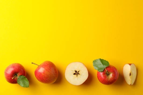 istock Flat lay with red apples on yellow background, space for text 1189098155