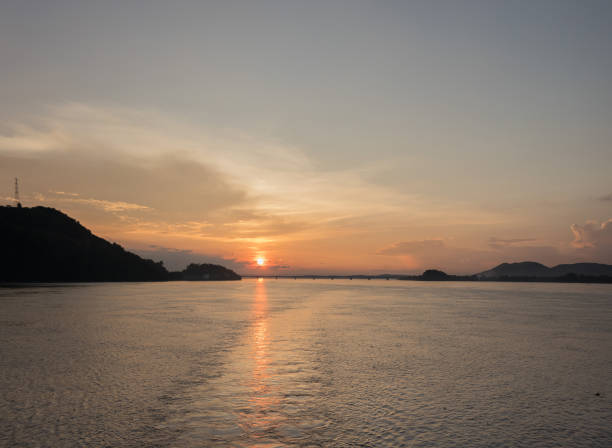 istock A beautiful orange sky with railway bridge, sunset and its shimmering reflection in the tranquil water of river Brahmaputra. 1189098483