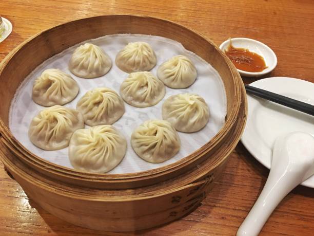 istock Chinese soup dumpling Xiao Long Bao in a bamboo steamer 1189099962