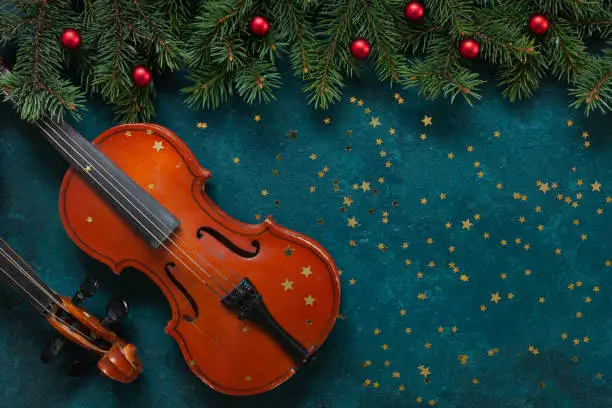Two Old violins and fir-tree branches with Christmas decoration wits glitter