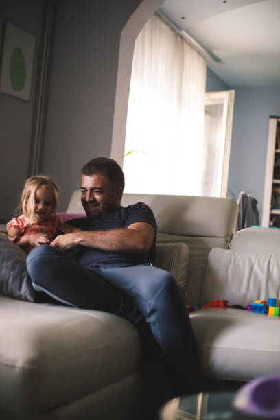 istock Father tickling his toddler daughter 1189100217