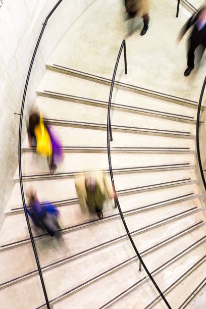 istock Blurred Motion of Urban People on Spiral Staircase 1189100341
