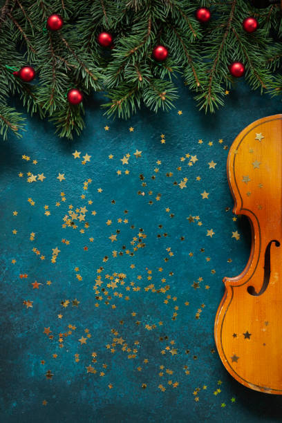 クリスマスの装飾が施された古いバイオリンとモミの木の枝 - ragtime ストックフォトと画像