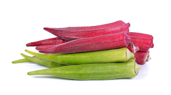 Fresh organic green and red okra isolated on a white background .