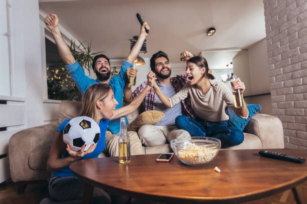 istock Friends watching sport on tv 1189101399
