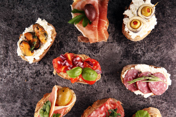 istock Appetizers table with italian antipasti snacks and wine in glasses. Brushetta or authentic traditional spanish tapas set, cheese variety 1189101688