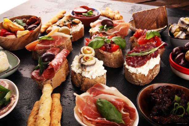 istock Appetizers table with italian antipasti snacks and wine in glasses. Brushetta or authentic traditional spanish tapas set, cheese variety 1189102002